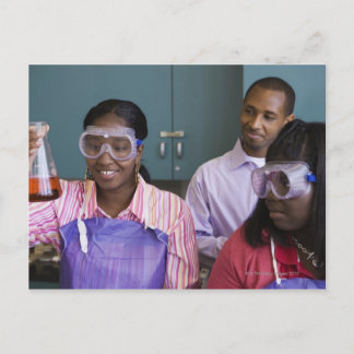 African teenage girl examining experiment in postcard