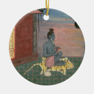 Aged ascetic seated on a tiger skin outside a buil ceramic tree decoration