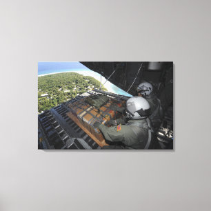 Airmen push out a pallet of donated goods 2 canvas print