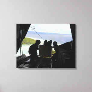 Airmen push out a pallet of donated goods 2 canvas print