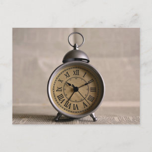 Alarm clock with roman numerals postcard