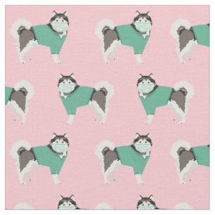 alaskan malamute in scrubs in pink fabric