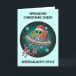 Alien Santa in UFO Christmas Holiday Card<br><div class="desc">Spread intergalactic holiday cheer with this one-of-a-kind Christmas card. Featuring an adorable alien cruising through space in a UFO, loaded with presents, and pulled by two robot-like reindeer. Perfect for anyone who loves a fun, futuristic twist on the holiday season. Send your warm wishes with a card that's out of...</div>