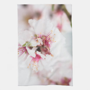 Almond tree flowers covered by snow tea towel
