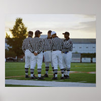 American football referees talking in field