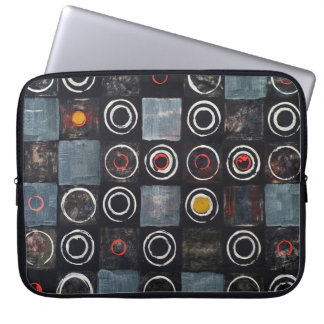 An abstract painting; a grid of stamped circles on laptop sleeve