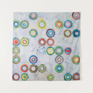 An abstract painting; multicolored circles on a gr tapestry