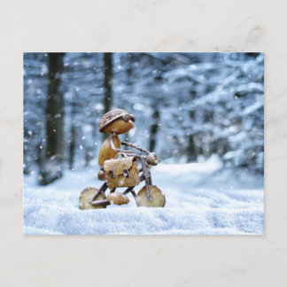 An acorn elf is biking to work in winter postcard