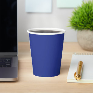 an aeroplane flying in the sky with a blue backgro paper cups