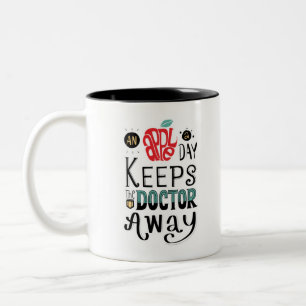 An apple a day keeps the doctor away Quote Two-Tone Coffee Mug