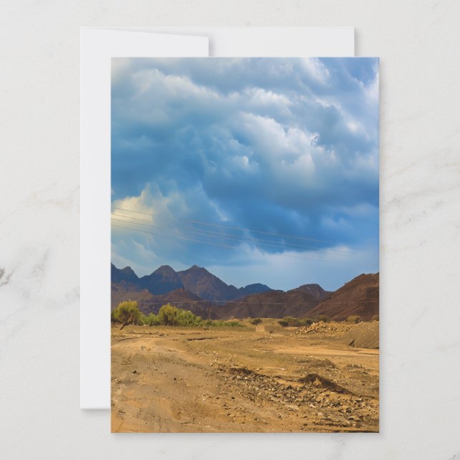 An arid landscape under a dramatic, cloudy sky holiday card (Front)