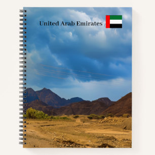 An arid landscape under a dramatic, cloudy sky notebook