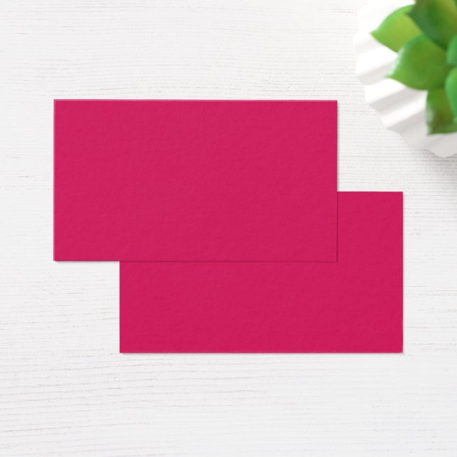 An array of red and pink flowers with lush green l (Desk)