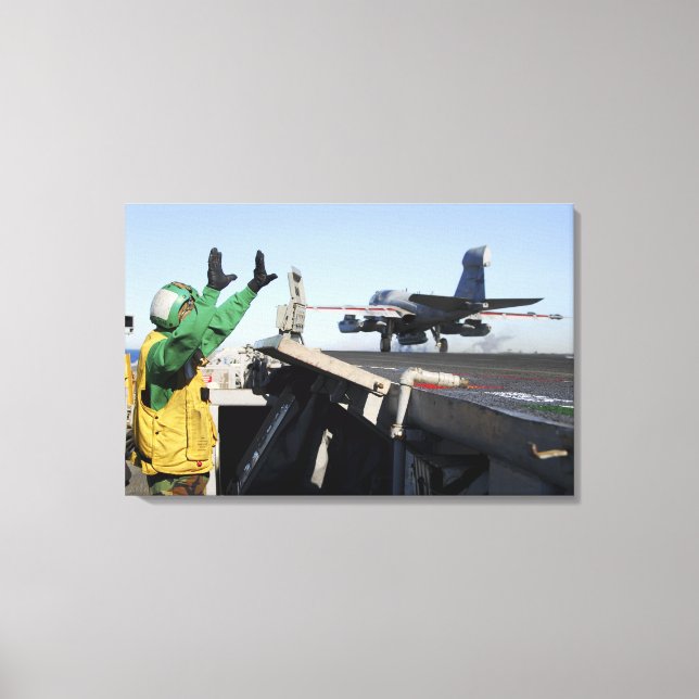 An EA-6B Prowler launches from the flight deck Canvas Print (Front)