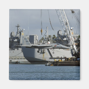 An F-15 Eagle gets a lift from a barge crane Magnet