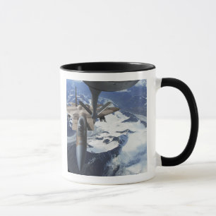 An F-15C Eagle aircraft sits behind a KC-135R Mug