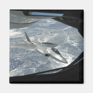 An F-22 Raptor banks away from a KC-135 Magnet