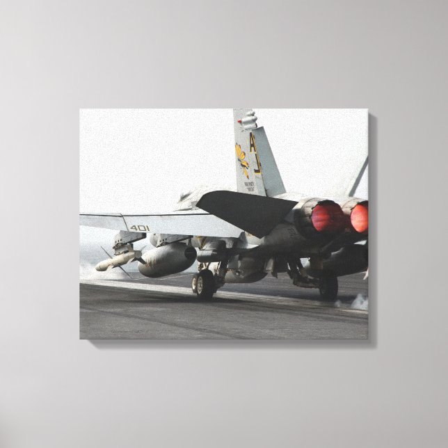 An F/A-18C Hornet launches from the flight deck Canvas Print (Front)