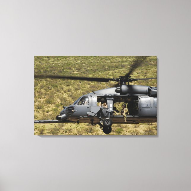 An HH-60 Pave Hawk flies over the desert Canvas Print (Front)