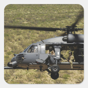 An HH-60 Pave Hawk flies over the desert Square Sticker