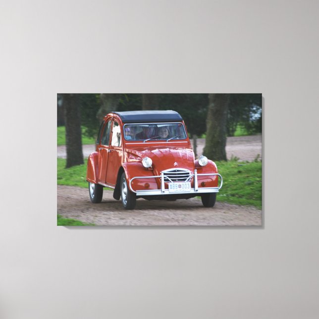 An old red Citroen 2CV car with a smiling woman Canvas Print (Front)