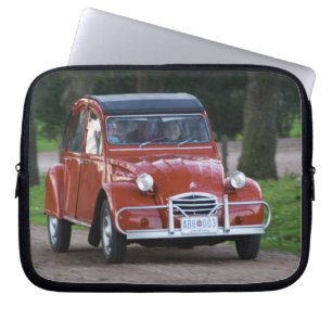 An old red Citroen 2CV car with a smiling woman Laptop Sleeve