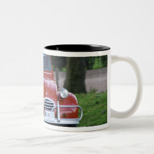 An old red Citroen 2CV car with a smiling woman Two-Tone Coffee Mug