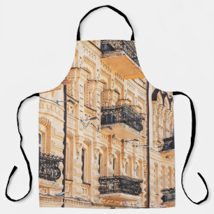 An old yellow house with wrought-iron balconies. f apron