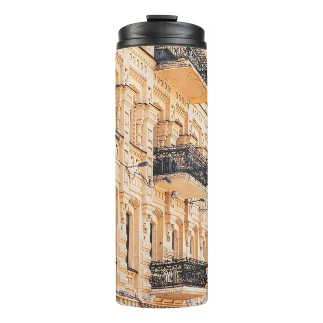 An old yellow house with wrought-iron balconies. f thermal tumbler (Front)
