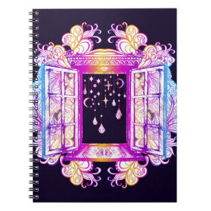 An open vintage window with pendants against a bac notebook