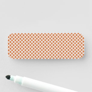 an orange and white geometric pattern name tag