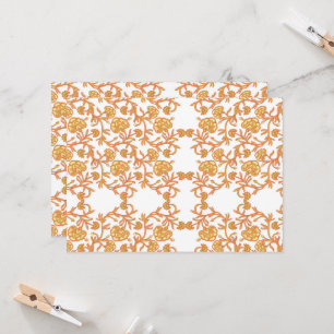 an orange and white wallpaper with a floral design invitation