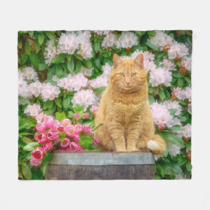 An Orange Cat in a Garden with Pink Spring Flowers Fleece Blanket