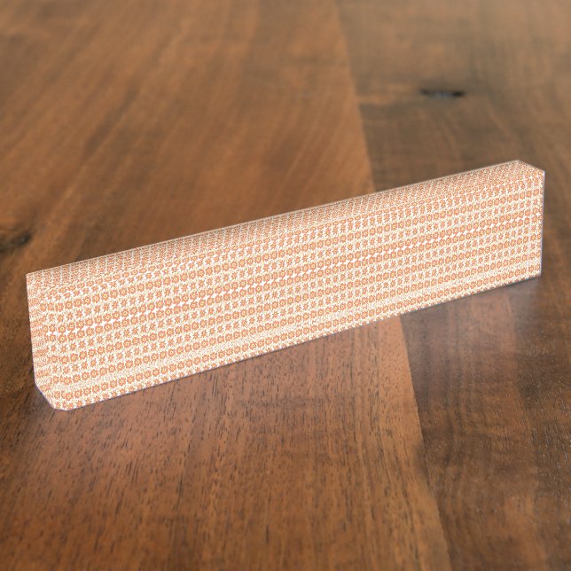 An orange rug with a textured pattern lies flat on nameplate (Side)