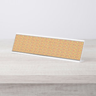 An orange, yellow, and brown symmetrical pattern w desk name plate