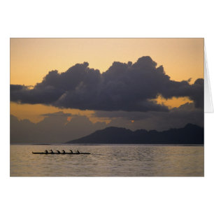 An outrigger canoe team practices off the coast