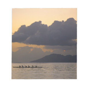 An outrigger canoe team practices off the coast notepad