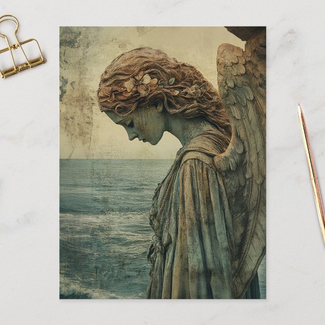 Angel Statue with Patina Postcard (Angel statue covered in patina and distressed on a postcard that is laid on a marble flat surface.)