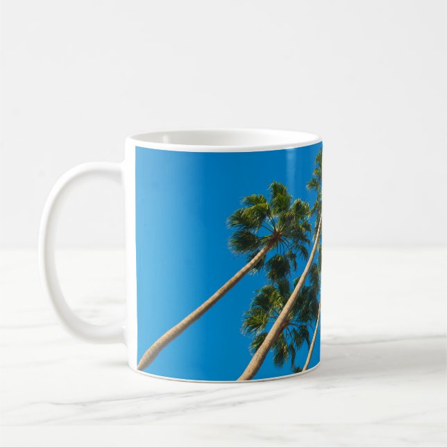 Angle perspective of group of tall thin palm trees coffee mug (Left)