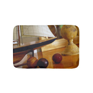 Antique Baseballs On A Table By A Model Sailboat Bath Mat