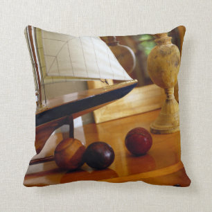 Antique Baseballs On A Table By A Model Sailboat Cushion