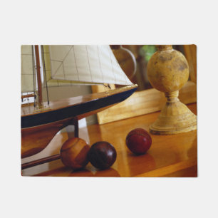 Antique Baseballs On A Table By A Model Sailboat Doormat