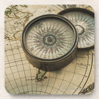 Antique compass on map coaster