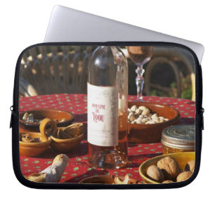 Aperitif and appetizers prepared: bread, olives, laptop sleeve