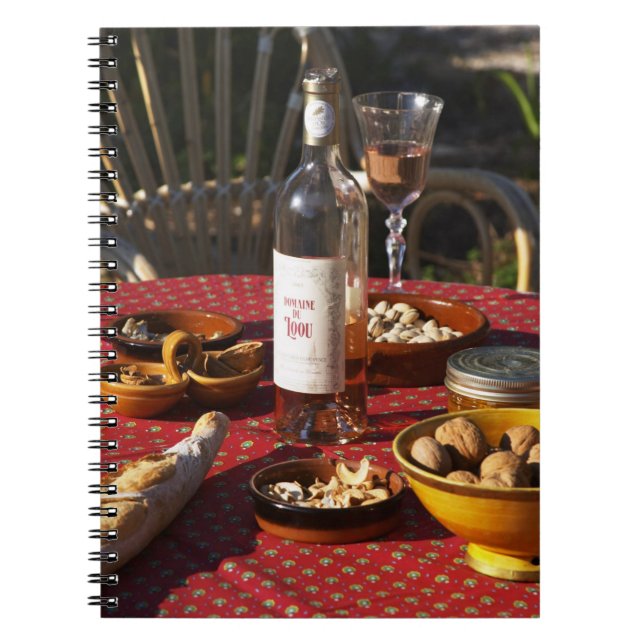 Aperitif and appetizers prepared: bread, olives, spiral notebook (Front)