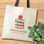 Apple And Books Custom Preschool Teacher Name Tote Bag<br><div class="desc">Make back to school extra special with this personalised teacher tote bag featuring a colourful stack of books topped with an apple. Add your teacher’s name and grade for a thoughtful,  practical gift they’ll use daily. Ideal for elementary,  kindergarten,  and preschool teachers who love a cheerful,  classroom-inspired design.</div>