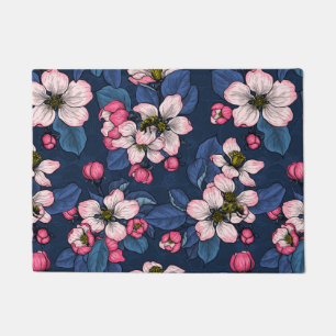 Apple blossom on a dark blue doormat