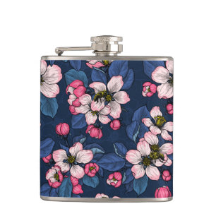 Apple blossom on a dark blue hip flask