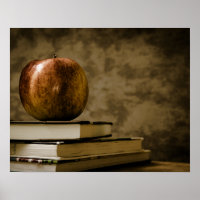 Apple on Top of a Stack of Books on a Desk