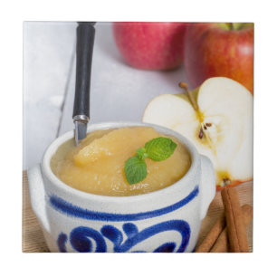 Applesauce with cinnamon in stoneware bowl tile
